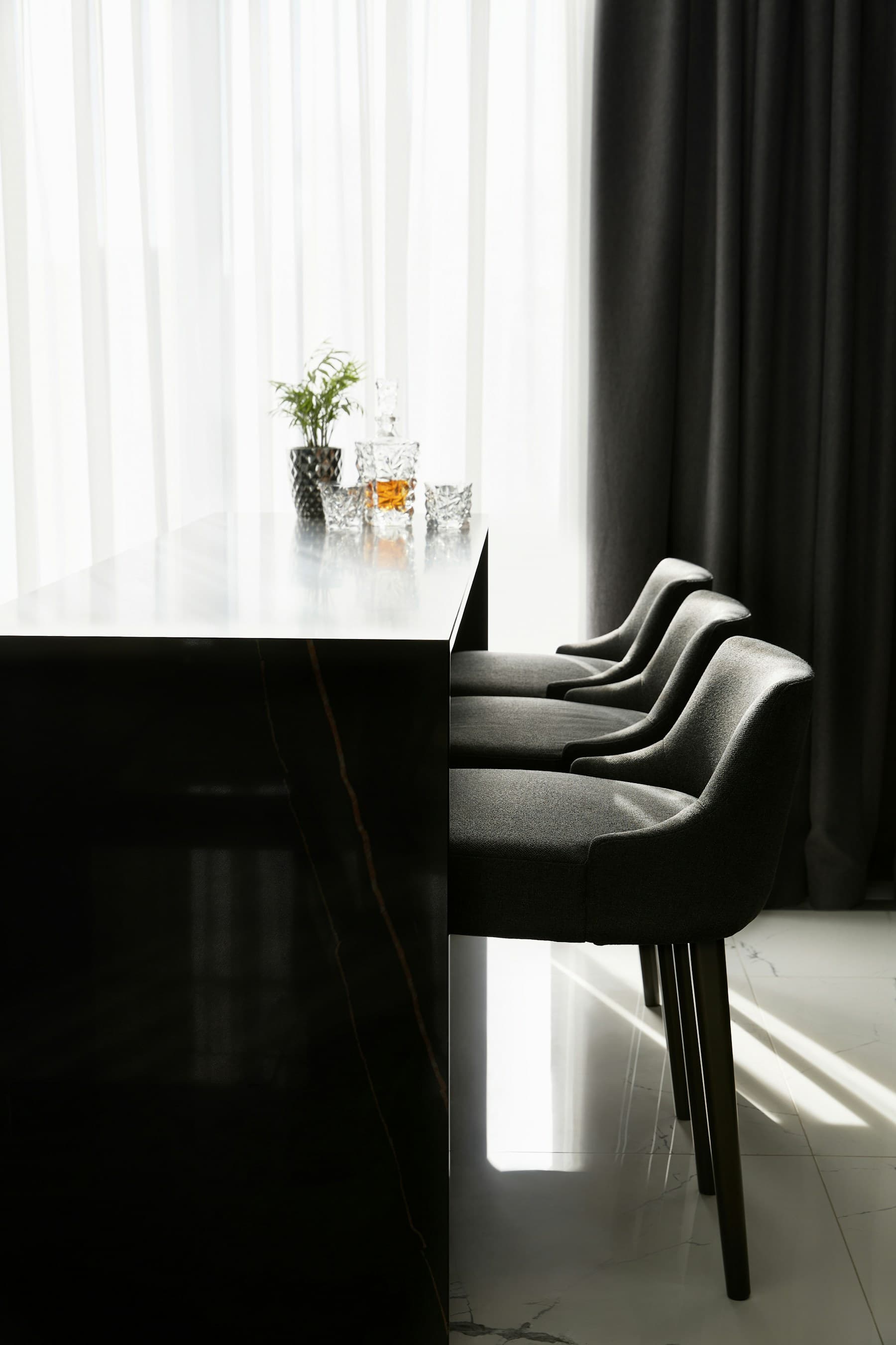 Dark waterfall bar with a polished stone top