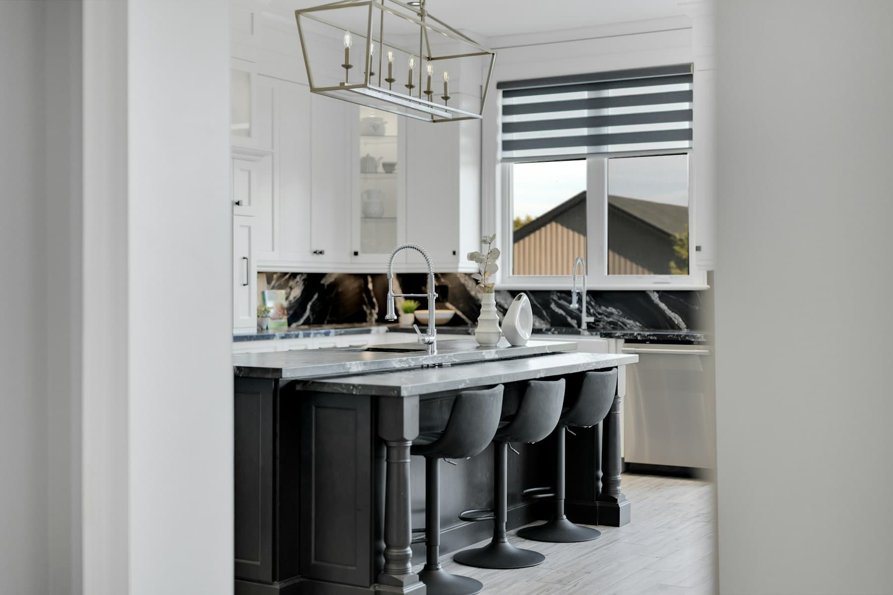 Black and white kitchen with stone island and backsplash